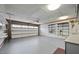 Spacious two car garage with finished walls and ceiling and functional storage shelving at 13019 N 23Rd Pl, Phoenix, AZ 85022