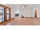 Spacious living room featuring a decorative brick fireplace, ceiling fan, and tile floors at 13019 N 23Rd Pl, Phoenix, AZ 85022