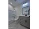 Updated bathroom with a gray vanity, dark hardware, and a shower-tub combo at 14860 S Capistrano Rd, Arizona City, AZ 85123