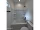 Clean bathroom featuring a shower-tub combo and a toilet at 14860 S Capistrano Rd, Arizona City, AZ 85123