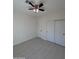 An interior view of bedroom with tiled floor, fan with lights, and closet at 14860 S Capistrano Rd, Arizona City, AZ 85123