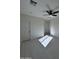 Bedroom featuring white walls, light floors, a ceiling fan, and two doors at 14860 S Capistrano Rd, Arizona City, AZ 85123