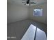 Bedroom featuring a ceiling fan, window, and light tile flooring at 14860 S Capistrano Rd, Arizona City, AZ 85123