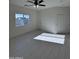 Spacious bedroom with white walls, light floors, a ceiling fan, and a closet at 14860 S Capistrano Rd, Arizona City, AZ 85123