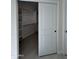 Walk-in closet with built-in shelves and sliding doors at 14860 S Capistrano Rd, Arizona City, AZ 85123