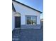 Charming single-story home with dark gray front door and window in a gray frame at 14860 S Capistrano Rd, Arizona City, AZ 85123