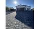Desirable single-story home featuring a gray two-car garage and dark gray brick driveway at 14860 S Capistrano Rd, Arizona City, AZ 85123