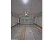 An empty new two-car garage provides a blank canvas for storage and projects at 14860 S Capistrano Rd, Arizona City, AZ 85123
