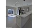 Bright kitchen featuring stainless steel appliances, gray cabinets, and a quartz countertop island at 14860 S Capistrano Rd, Arizona City, AZ 85123