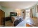 Cozy bedroom with hardwood floors, floral bedding, and natural light from the window at 1500 N Markdale -- # 68, Mesa, AZ 85201