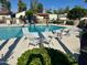 Inviting community pool area with lounge chairs and tables under the bright sun at 1500 N Markdale -- # 68, Mesa, AZ 85201