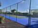 Community tennis court surrounded by a chain link fence at 1500 N Markdale -- # 68, Mesa, AZ 85201