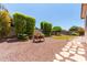 Well-maintained backyard with gravel, artificial grass, and mature landscaping at 157 W Leatherwood Ave, San Tan Valley, AZ 85140