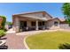 Desert backyard includes artificial turf, a covered patio, and a barbecue grill with desert landscaping at 157 W Leatherwood Ave, San Tan Valley, AZ 85140