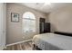 This charming bedroom includes a window, television, and wardrobe at 157 W Leatherwood Ave, San Tan Valley, AZ 85140