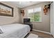 Well-lit bedroom with a queen size bed, a painting and elephant themed shelves at 157 W Leatherwood Ave, San Tan Valley, AZ 85140