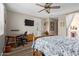 Bright bedroom with ceiling fan, desk, and access to the outdoor patio at 157 W Leatherwood Ave, San Tan Valley, AZ 85140