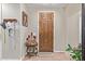 Inviting entryway featuring a wooden door, decor, tiled floor, and wall art at 157 W Leatherwood Ave, San Tan Valley, AZ 85140