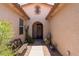 Covered entryway featuring a decorative front door, tiled walkway, bench and plants at 157 W Leatherwood Ave, San Tan Valley, AZ 85140
