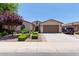Inviting single-Gathering home featuring a desert landscape, a two-car garage, and neutral-toned stucco at 157 W Leatherwood Ave, San Tan Valley, AZ 85140