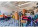 Organized garage with storage cabinets, a diamond pattern floor, and various household items at 157 W Leatherwood Ave, San Tan Valley, AZ 85140