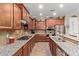 Well-equipped kitchen boasts granite countertops, stainless steel appliances, and ample counter space at 157 W Leatherwood Ave, San Tan Valley, AZ 85140