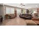 Spacious living room with comfortable seating, ceiling fans, and tile flooring at 157 W Leatherwood Ave, San Tan Valley, AZ 85140