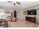 Cozy living room features neutral walls, tile flooring, and comfortable seating arrangement at 157 W Leatherwood Ave, San Tan Valley, AZ 85140