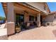 Covered patio features an awning, a ceiling fan, ample seating, and a barbecue grill at 157 W Leatherwood Ave, San Tan Valley, AZ 85140
