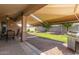 Relaxing covered patio with outdoor seating and desert landscaping, including a built-in barbecue at 157 W Leatherwood Ave, San Tan Valley, AZ 85140