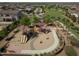 Aerial view of a community playground with modern equipment and shaded seating areas at 157 W Leatherwood Ave, San Tan Valley, AZ 85140