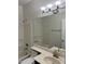 Bathroom featuring a shower over the tub, a toilet, and a single sink with mirror at 15801 W Meade Ln, Goodyear, AZ 85338