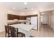 Kitchen featuring an island with seating, cabinetry, and a full suite of white appliances at 16450 E Avenue Of The Fountain Ave # 11, Fountain Hills, AZ 85268