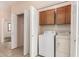 Functional laundry area with tiled flooring and a set of white washer and dryer units at 16450 E Avenue Of The Fountain Ave # 11, Fountain Hills, AZ 85268