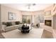 Cozy living room featuring a fireplace, plush seating, and large windows with natural light at 16450 E Avenue Of The Fountain Ave # 11, Fountain Hills, AZ 85268