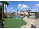 Expansive backyard with a lush lawn, fenced pool, hot tub, outdoor kitchen, and ample space for relaxation at 16608 S 16Th Ave, Phoenix, AZ 85045