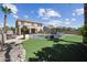 Spacious backyard featuring a refreshing pool, outdoor kitchen, manicured lawn, and privacy landscaping at 16608 S 16Th Ave, Phoenix, AZ 85045