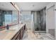 Bathroom with double vanity, large mirror, and beautifully tiled shower with natural light at 16608 S 16Th Ave, Phoenix, AZ 85045