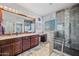 Bathroom with double vanity, large mirror, plenty of natural light, and modern glass shower at 16608 S 16Th Ave, Phoenix, AZ 85045