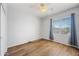 Bedroom with hardwood floors, a ceiling fan, and a window with neighborhood views at 16608 S 16Th Ave, Phoenix, AZ 85045