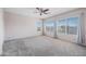 Bright and airy bedroom with large windows, neutral carpet, and a ceiling fan for added comfort at 16608 S 16Th Ave, Phoenix, AZ 85045
