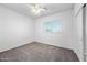 Bright, empty bedroom with neutral carpet, ceiling fan and a window with views at 16608 S 16Th Ave, Phoenix, AZ 85045