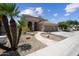 Charming home featuring a beautifully landscaped front yard with a stone pathway and mature palm trees at 16608 S 16Th Ave, Phoenix, AZ 85045