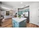 Open kitchen layout with an island, stainless steel refrigerator, and easy access to the living room at 16608 S 16Th Ave, Phoenix, AZ 85045