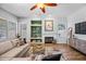 Well-lit living room with hardwood floors, neutral walls, gas fireplace, and built-in shelving at 16608 S 16Th Ave, Phoenix, AZ 85045