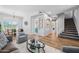 Spacious living area featuring hardwood floors, neutral walls, and views into the dining area and kitchen at 16608 S 16Th Ave, Phoenix, AZ 85045