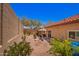 Landscaped backyard with outdoor seating, desert plants, and block wall fencing at 1702 W Amberwood Dr, Phoenix, AZ 85045