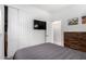 Bedroom with a TV, closet, light walls, and a queen size bed at 1702 W Amberwood Dr, Phoenix, AZ 85045