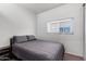Bedroom with a bed, neutral carpet, and a window providing natural light at 1702 W Amberwood Dr, Phoenix, AZ 85045