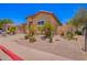 Beautiful home with desert landscaping including palm trees, cacti, and other arid plants at 1702 W Amberwood Dr, Phoenix, AZ 85045